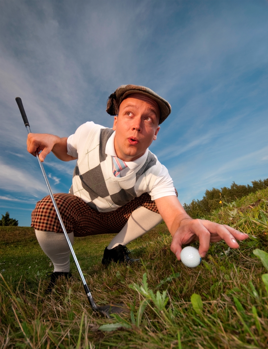 Golfer picking up ball to cheat