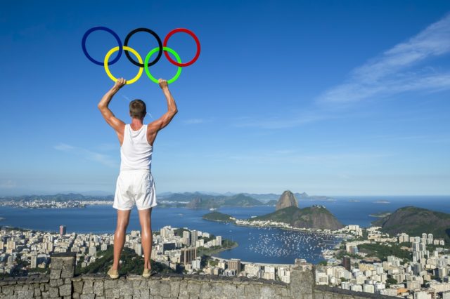 Man looking down on Rio with Olympic rings