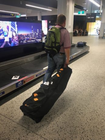 Golf travel bag being pulled by man at airport