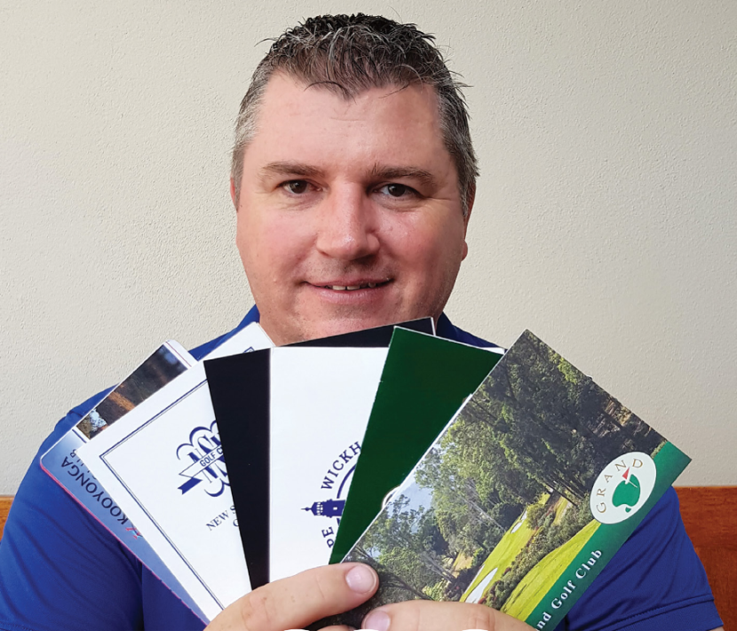 Carl Murphy holding top 100 golf course scorecards